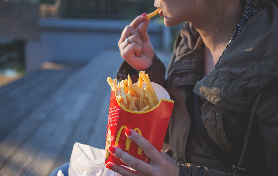 A person eating McDonald's French fries