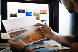 A graphic designer looking at their work