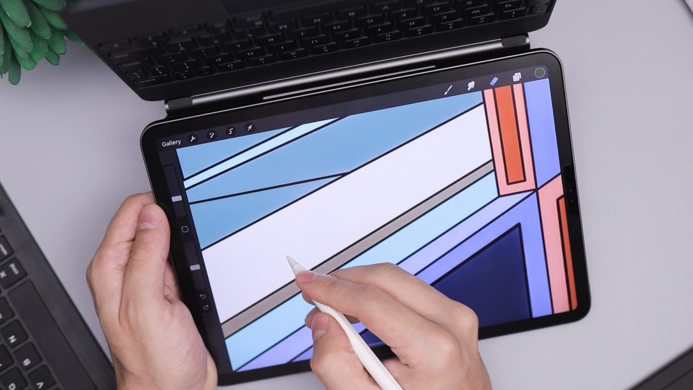 A person drawing a design on an iPad