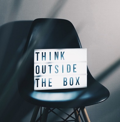 A card on a chair that says, ‘think outside the box.’