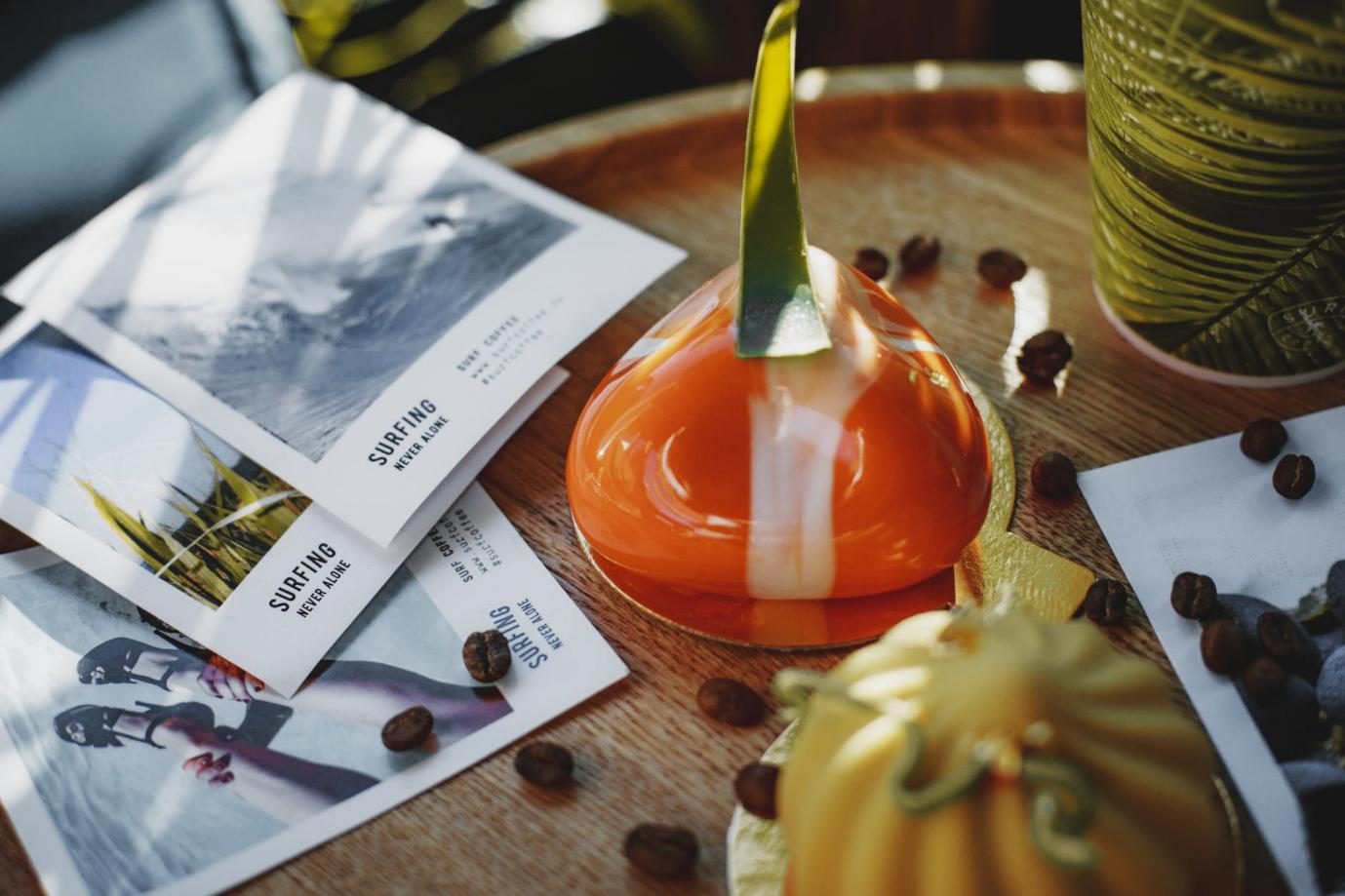 Flyers, coffee beans, and other decorative items on table.