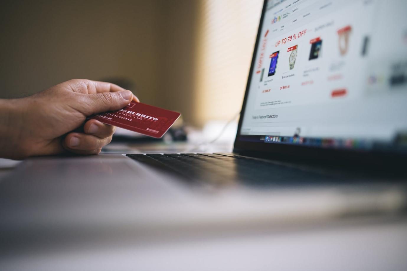 Person using credit card to shop online.